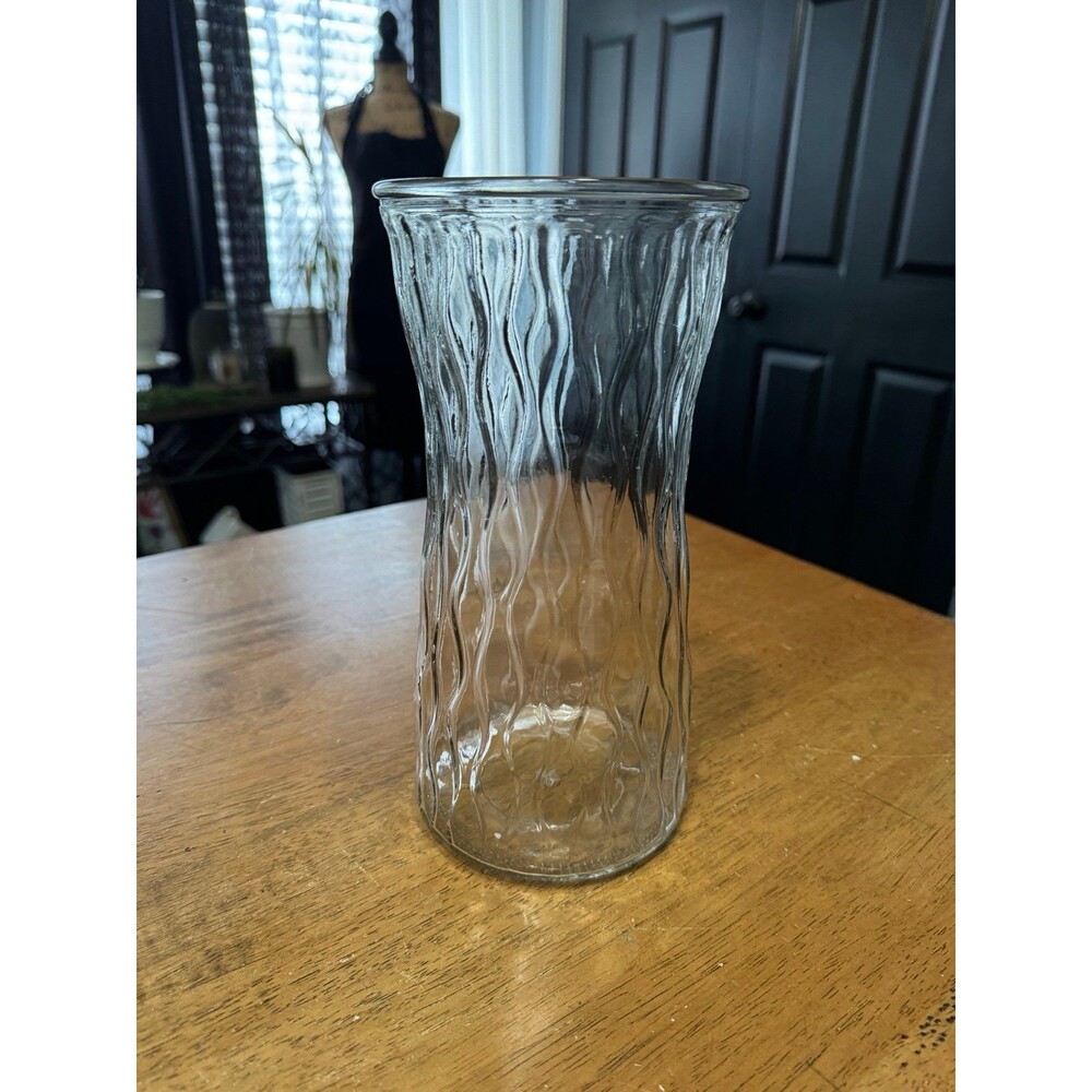 vintage clear glass vase features a distinctive vertical swirl pattern